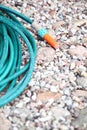 Garden water hose outdoor sand Royalty Free Stock Photo