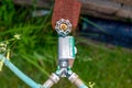 Garden water timer on a spigot with a splitter and hoses. Royalty Free Stock Photo