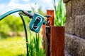Garden water timer on a spigot with a splitter and hoses.