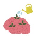 Garden watering can water the plants in the brains. the concept of self-development, education, creativity