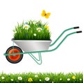 Garden Wheelbarrow And Grass With Flowers