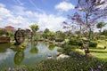 Garden with watermill. Beautiful weather with blue sky. Royalty Free Stock Photo