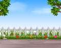 Garden with wooden fence and road Royalty Free Stock Photo