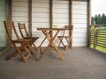 Garden wooden furniture, two chairs and a table in a country house on the terrace or in a hotel. On the table are two glasses of Royalty Free Stock Photo