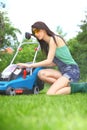 Garden work, woman mowing grass with lawnmower Royalty Free Stock Photo