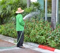 Garden worker are watering and splashing flowers and trees