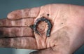 Garden worm twisted on a dirty human palm