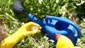 Gardener adding fertilizer for plants to watering can