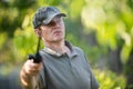 Gardener applying an insecticide fertilizer to his fruit shrubs Royalty Free Stock Photo