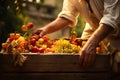 gardener with crate of assorted freshness fruits. harvest concept