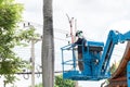 Gardener cutting branches on crane basket. unsafe concept Royalty Free Stock Photo