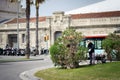 Gardener is cutting bushes and street of Barcelona town.