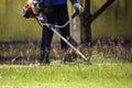 The gardener cutting grass by lawn mower