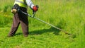 The gardener cutting grass by lawn mower, lawn care Royalty Free Stock Photo