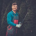 Gardener cutting trees with clippers Royalty Free Stock Photo