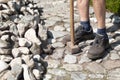 a gardener in dirty work clothes and boots holds a two-bladed iron hammer Royalty Free Stock Photo