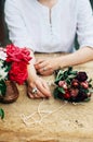 Gardener doing gardening work at a table rustic. Working in the garden, close up of the hands of a woman cares flowerscarnations. Royalty Free Stock Photo