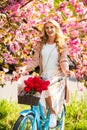 Gardener. girl under sakura with vintage bicycle. spring beauty and fashion. cherry tree pink blossom. perfect smell