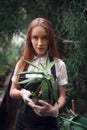 Gardener holding succulent plant in hands.