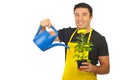 Gardener holding watering can and flower