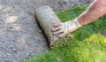 Gardener installing rolls of sod grass Royalty Free Stock Photo