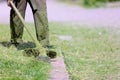 Gardener landscaper worker cutting green grass