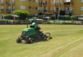 Gardener in lawn mower, maintenance service of the gardens in Costa Ballena resort, Rota, province of Cadiz, Spain