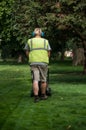 gardener with Lawn mower in a public garden