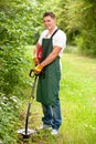 Gardener with lawn trimmer Royalty Free Stock Photo