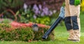 Gardener with Leaf Blower in His Hand Cleaning Residential Garden Royalty Free Stock Photo