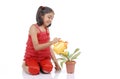 Gardener little girl watering plant