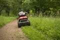 gardener mowing lawn, cutting grass in garden Royalty Free Stock Photo