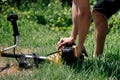 Gardener mows the grass with a trimmer in the yard in the summer Royalty Free Stock Photo