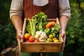Gardener offers wooden box full of fresh vegetables