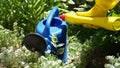 Gardener pouring watering can of fertilizer for plants closeup