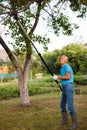 Gardener with prunning tool - lopper cutter