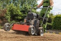 Gardener Pushing Gasoline Lawn Aerator