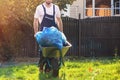 The gardener rolls a cart with bags of leaves. Cleaning the yard. Close up