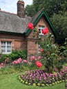 The Gardener`s Cottage with beautiful roses in Princes Street Gardens, Edinburgh, Scotland Royalty Free Stock Photo