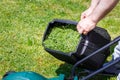 The gardener takes off the container with freshly mown grass Royalty Free Stock Photo