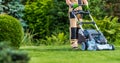 Gardener Trimming Grass Lawn Using Electric Cordless Mower Royalty Free Stock Photo