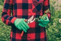 The gardener trims the bushes. Pruning bushes with garden pruning shears. Work in the garden. Royalty Free Stock Photo