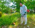 Gardener using brush cutter