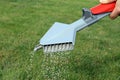 A Gardener fertilizing a lawn