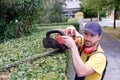 Gardener using an hedge clipper in the garden