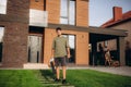 Gardener using leaf blower, vacuum and working in garden Royalty Free Stock Photo