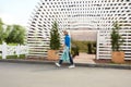 Gardener Walking Past Greenhouse