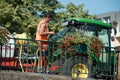 Gardener watering flowers on bridge