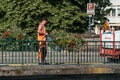 Gardener watering flowers on bridge