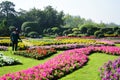 The gardener is watering the flowers at the park at Long 9 Park. Bangkok Thailand The beautiful flower garden.